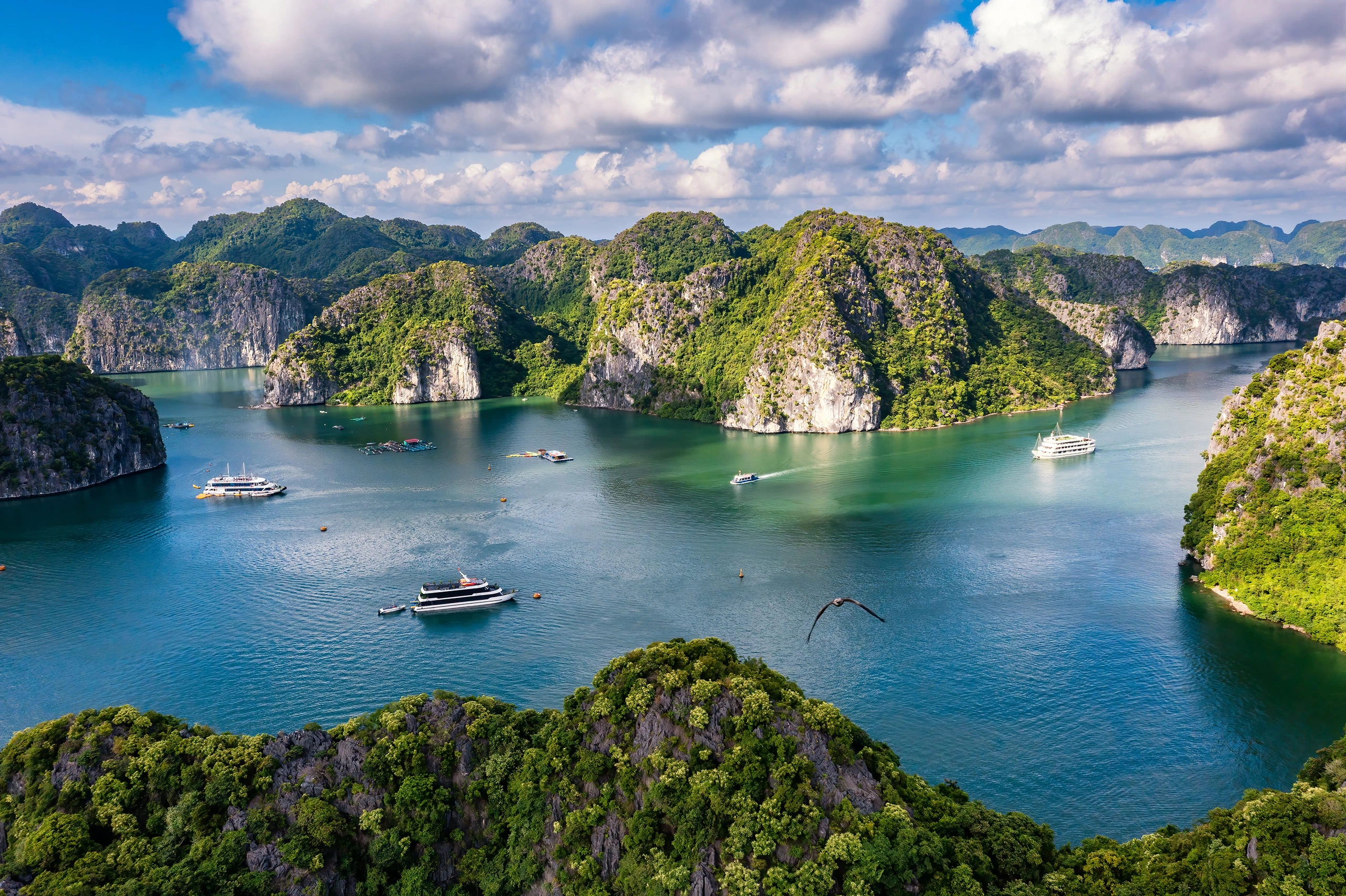 An ultra-wide panoramic aerial shot of the Halong Bay-Cat Ba Archipelago