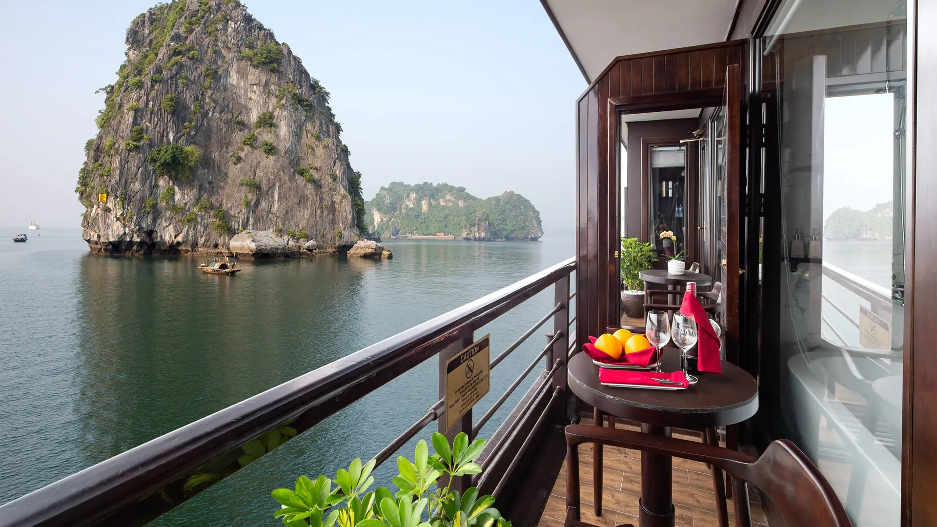 Private balcony overlooking limestone karsts on Peony Cruise Halong Bay